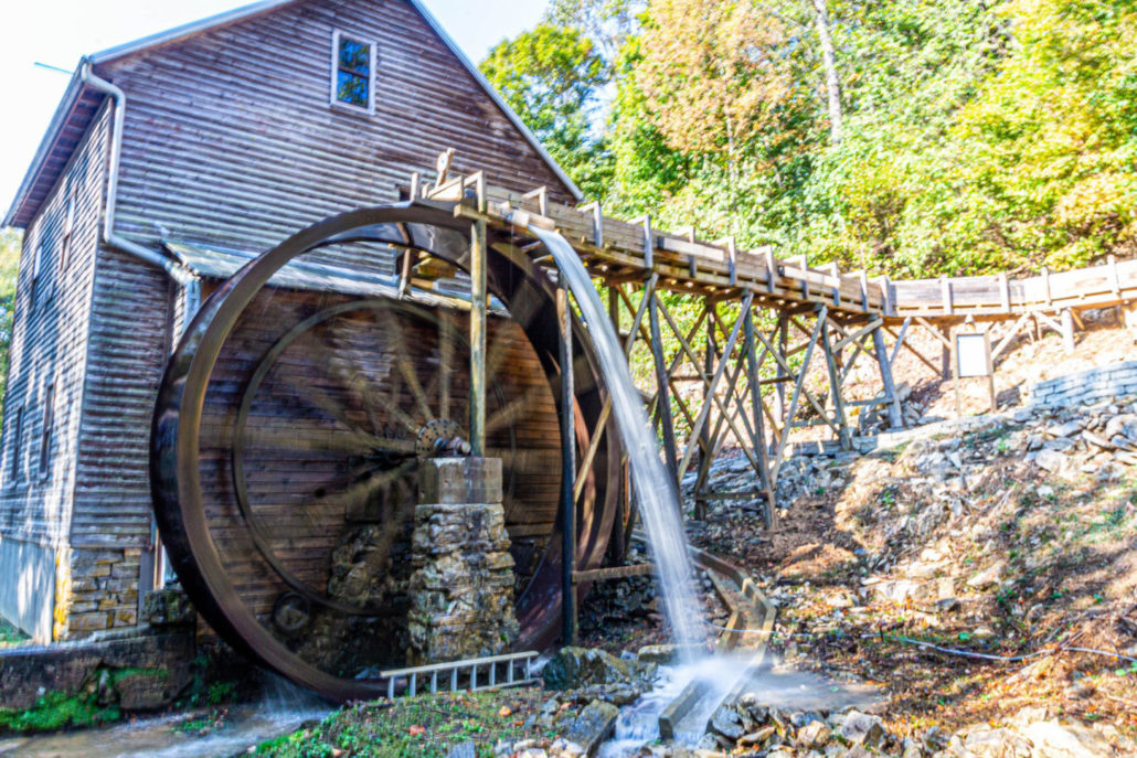 A photo of Bush Mill with the water wheel turning.